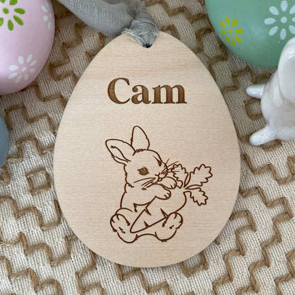 EASTER EGG SHAPED TAG WITH EASTER BUNNY HOLDING A CARROT